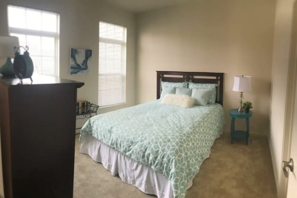 Resident bedroom with lots of window lighting at Lakeshore Apartment Homes in Evansville, Indiana