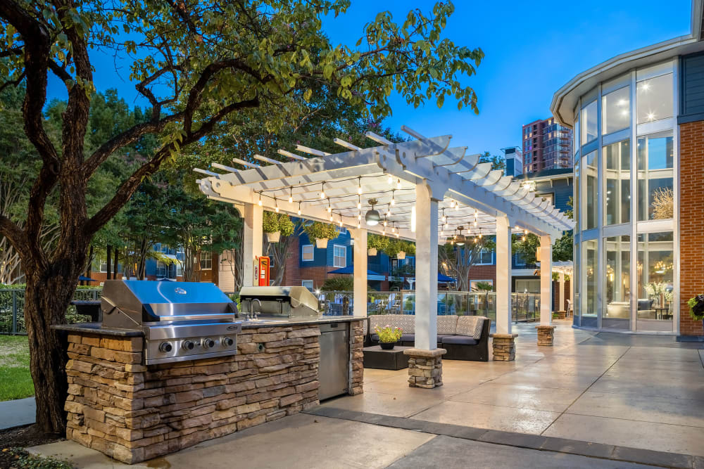 Evening view of outdoor patio with grill at Marquis on Gaston in Dallas, Texas