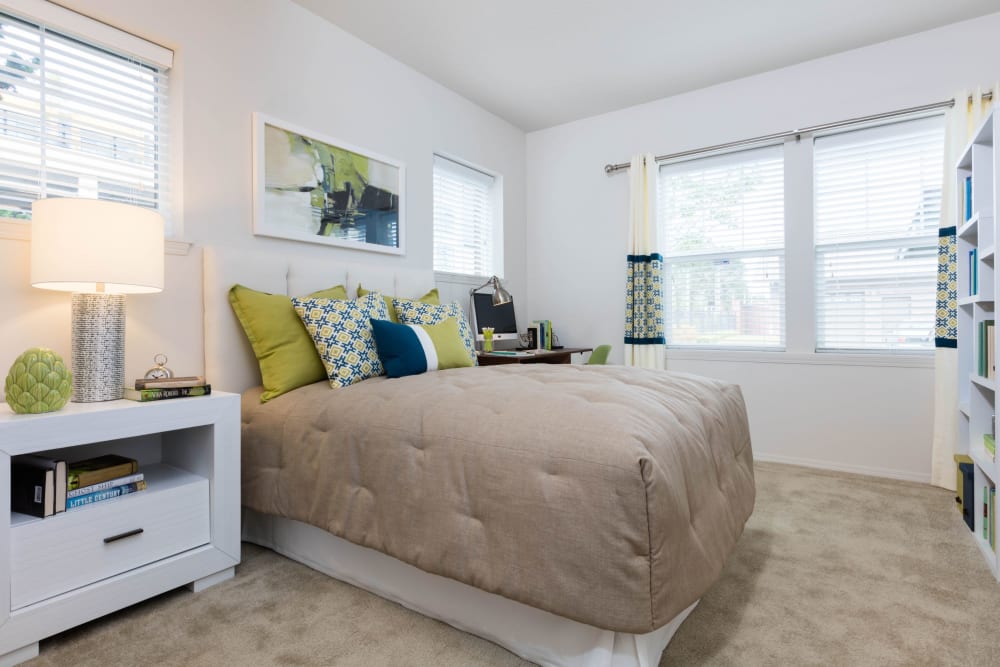 Model bedroom with carpet and large windows at Avery at Orenco Station in Hillsboro, Oregon