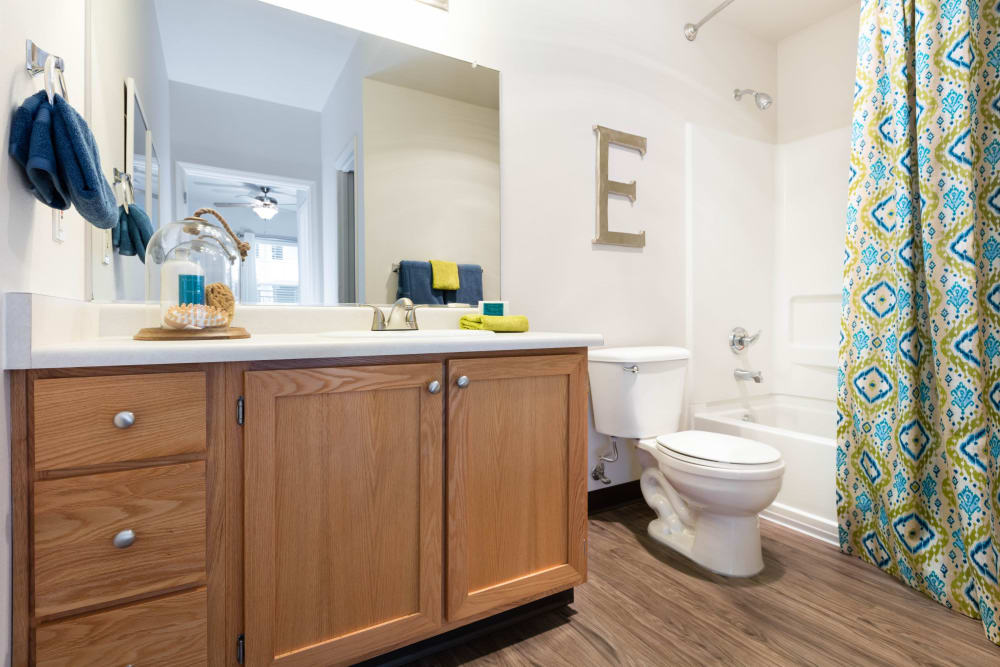 Model bathroom with wood-style flooring at Avery at Orenco Station in Hillsboro, Oregon