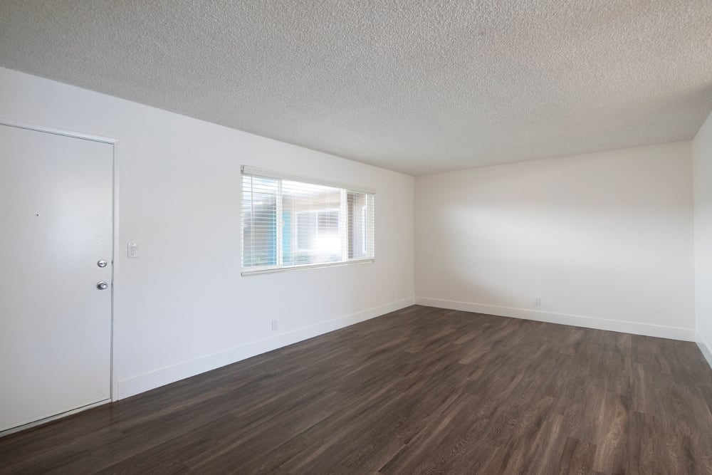 Spacious apartment with wood-style flooring at Villas at Carlsbad in Carlsbad, California