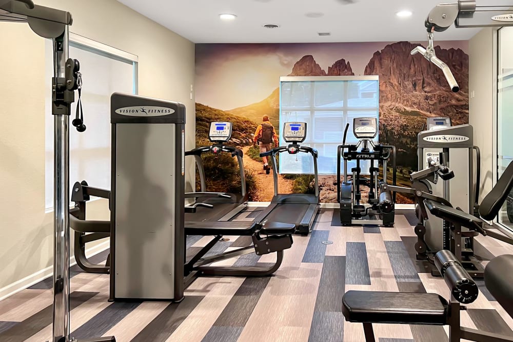 Fitness center with plenty of individual workout stations at Alton Green Apartments in Denver, Colorado