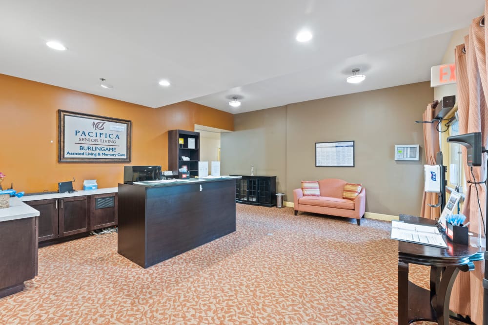 Reception area with couch seating at Pacifica Senior Living Burlingame in Burlingame, California