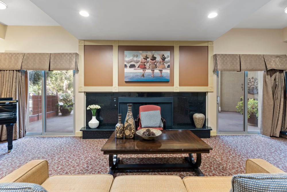 Lounge area with couch and artwork at Pacifica Senior Living Burlingame in Burlingame, California