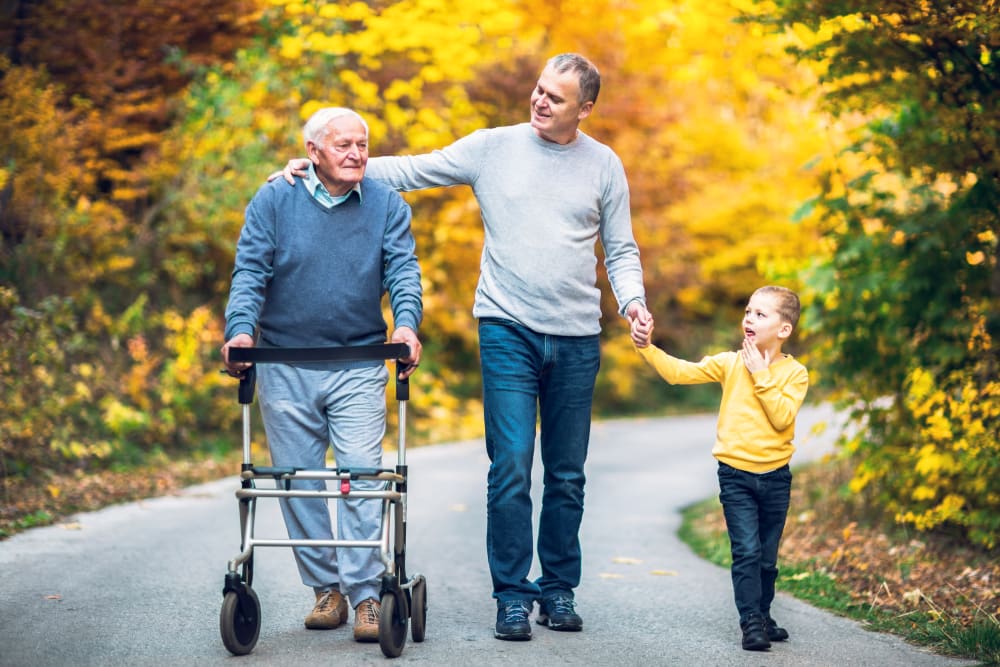 A resident with his son and grandchild on a walk near Cedarview Gracious Retirement Living in Woodstock, Ontario