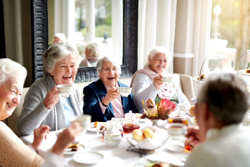 A group of residents having tea together at Victoria Park Personal Care Community in Regina, Saskatchewan