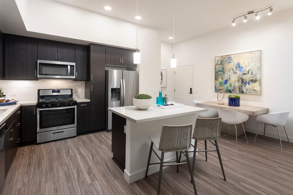 Model kitchen space with an island at The Residences at Escaya in Chula Vista, California