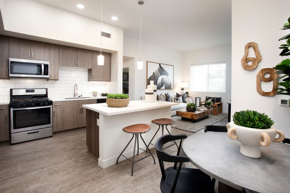Model kitchen space with a bar space at The Residences at Escaya in Chula Vista, California