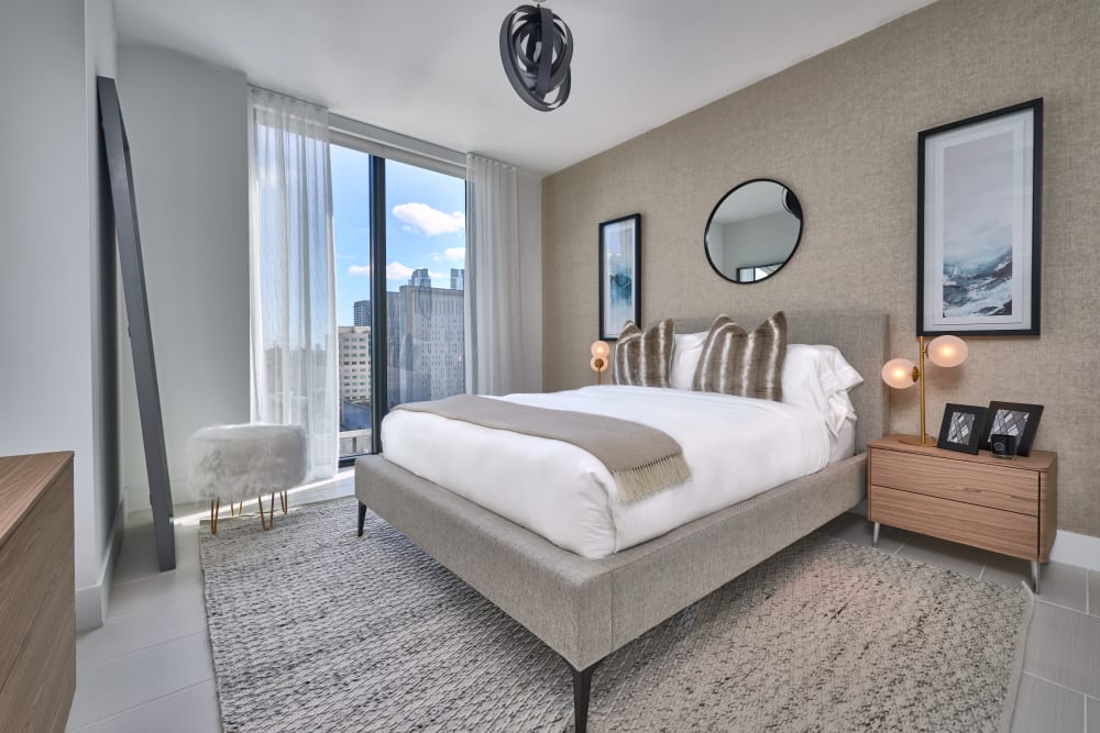 Spacious bedroom with an area rug and a large window at ParkLine Miami in Miami, Florida