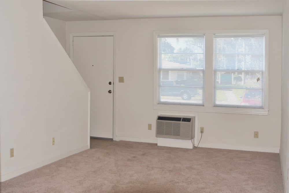 Living room with air conditioning at St. Johns Landing Apartments in Green Cove Springs, Florida