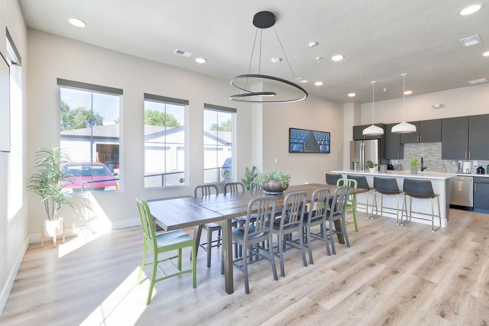 Interior of leasing office at Fields on 15th Apartment Homes in Longmont, Colorado with table and kitchen area.