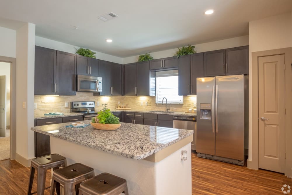 Kitchen with a chef's island at The Columns at Shadow Creek in Pearland, Texas