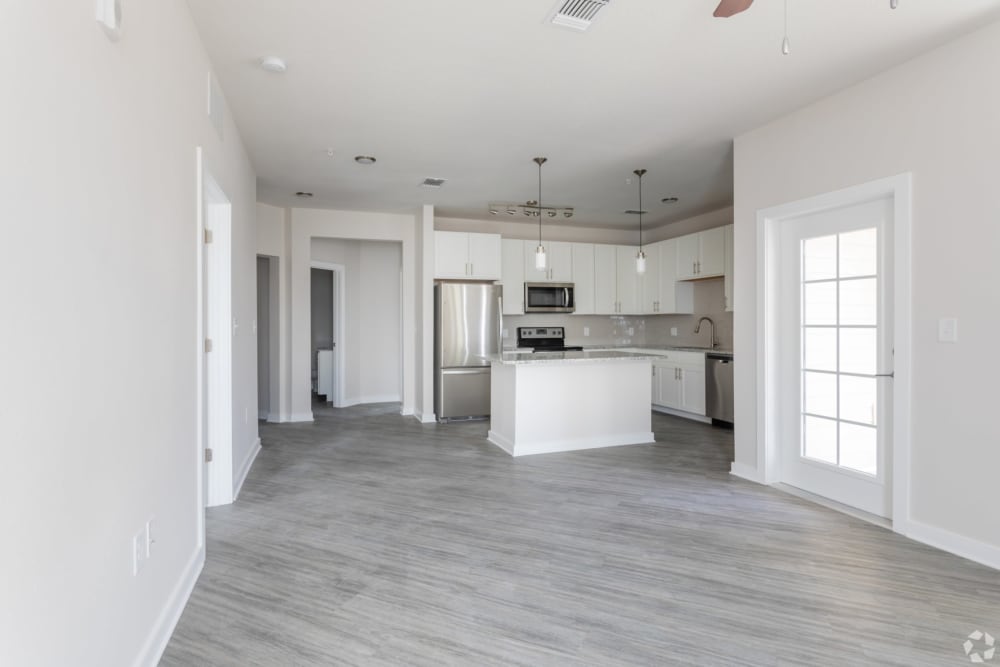 Living room with kitchen counter seating at Estero Parc in Estero, Florida