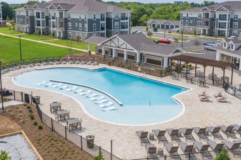Resort-style swimming pool with lots of lounge chairs at The Columns on Main in Spring Hill, Tennessee