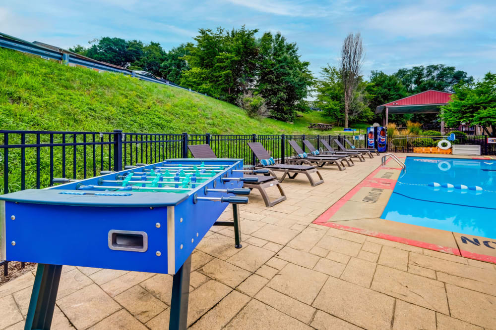 Swimming pool and lounge area with foosball table at Park Place of South Park in South Park, Pennsylvania