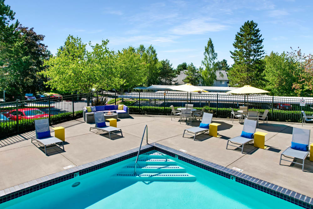 Beautiful resort-style swimming pool with lounge chairs at Cascade Ridge in Silverdale, Washington