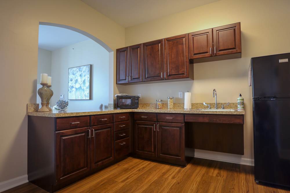 Kitchen with walnut color cabinet at Harmony at Martinsburg in Martinsburg, West Virginia