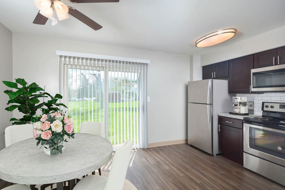 Kitchen with wood flooring and patio access at River Pointe in Bethlehem, Pennsylvania