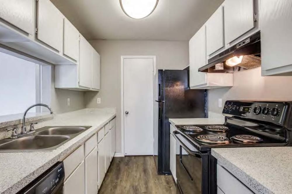 White cabinets in an apartment kitchen at Clear Fork Trail in Benbrook, Texas