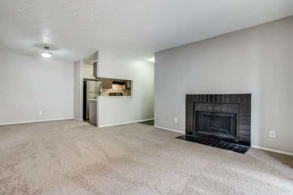 An apartment living room with a fireplace at Clear Fork Trail in Benbrook, Texas