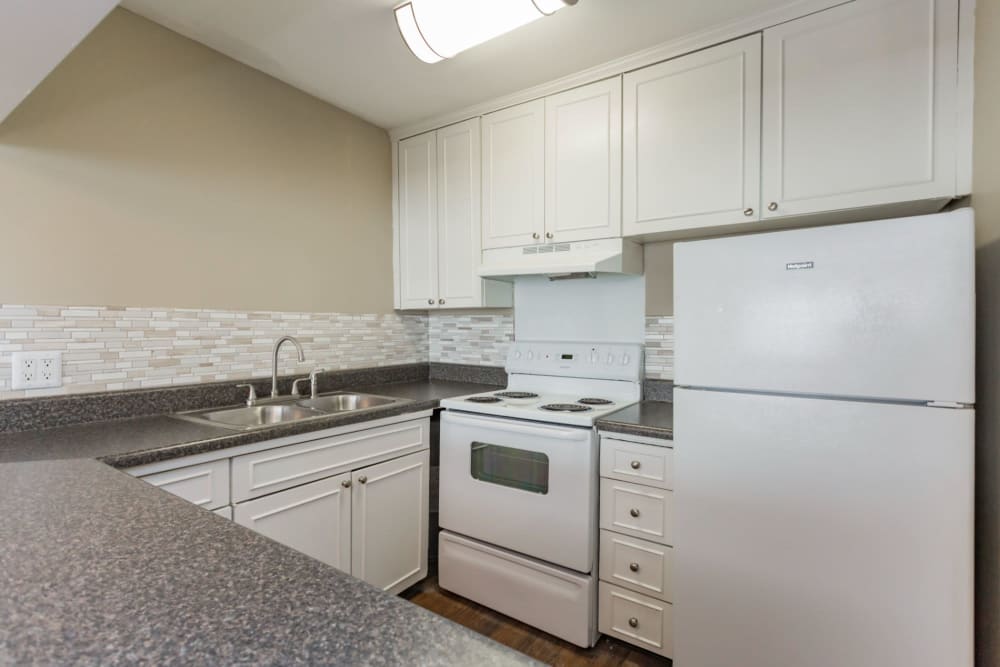 Kitchen with white cabinets at Belmont Place Apartments in Nashville, Tennessee
