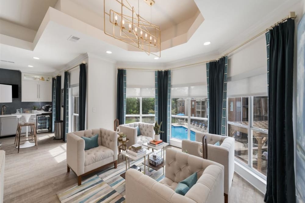 Comfortable lounge seating with a view of the pool in the clubhouse at Chace Lake Villas in Birmingham, Alabama