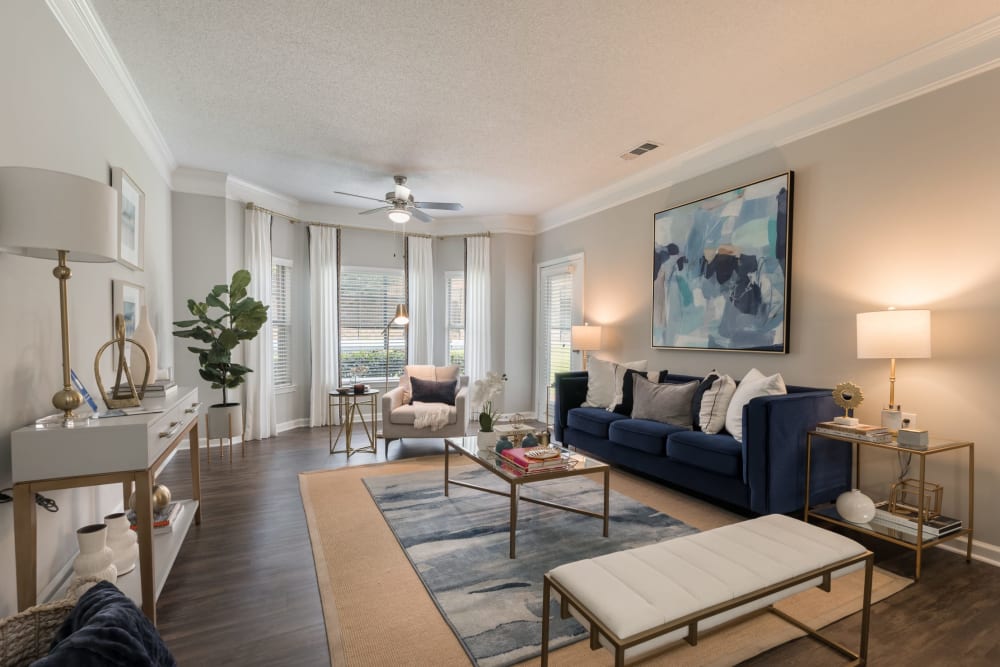 A furnished apartment living room with a door to the patio at Chace Lake Villas in Birmingham, Alabama