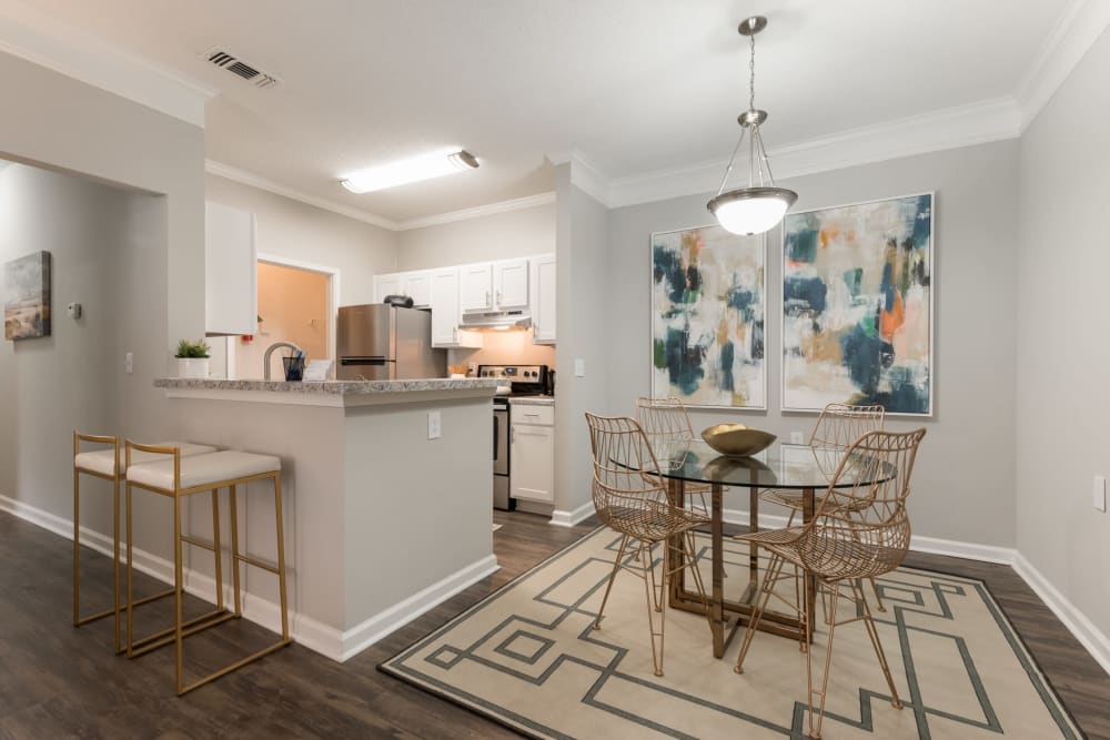 An apartment dining room and kitchen with bar seating at Chace Lake Villas in Birmingham, Alabama