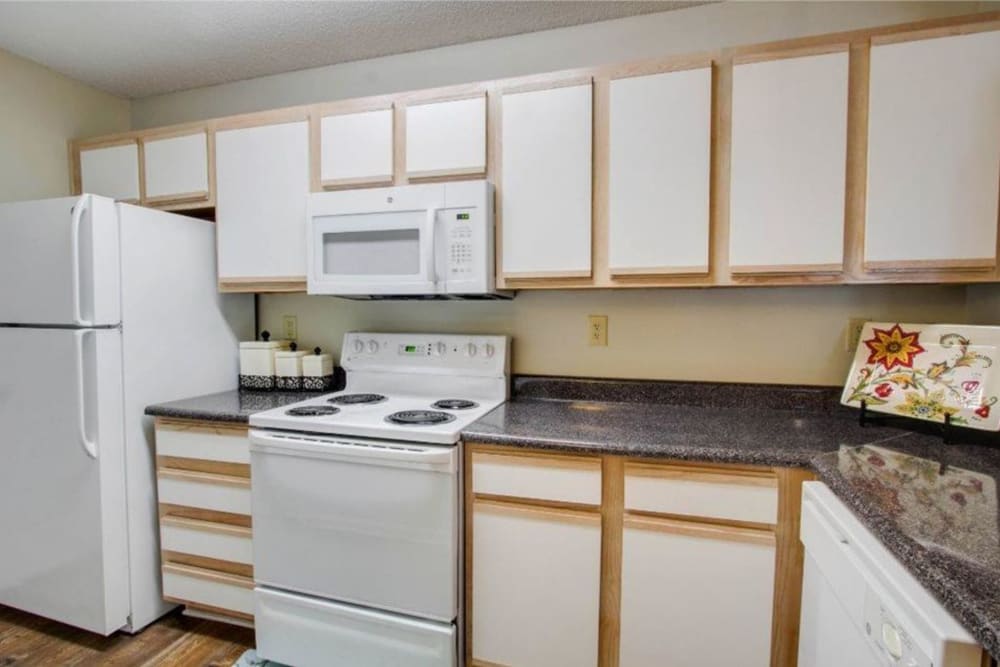 White cabinets and appliances in an apartment kitchen at The Gables in Ridgeland, Mississippi