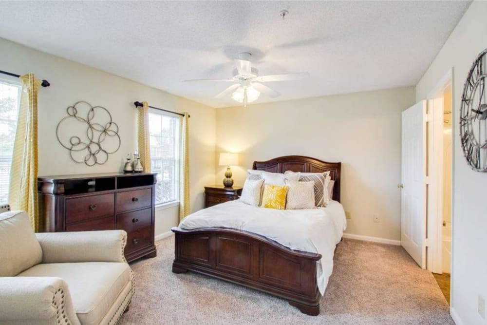 A spacious, furnished apartment bedroom at The Gables in Ridgeland, Mississippi