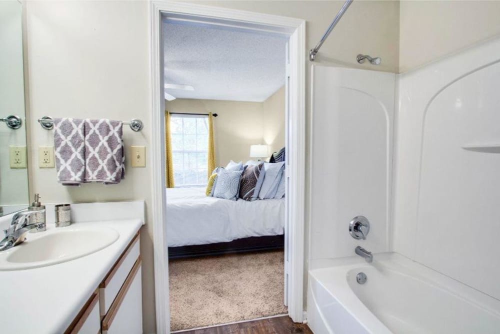 A bedroom with an attached bathroom at The Gables in Ridgeland, Mississippi