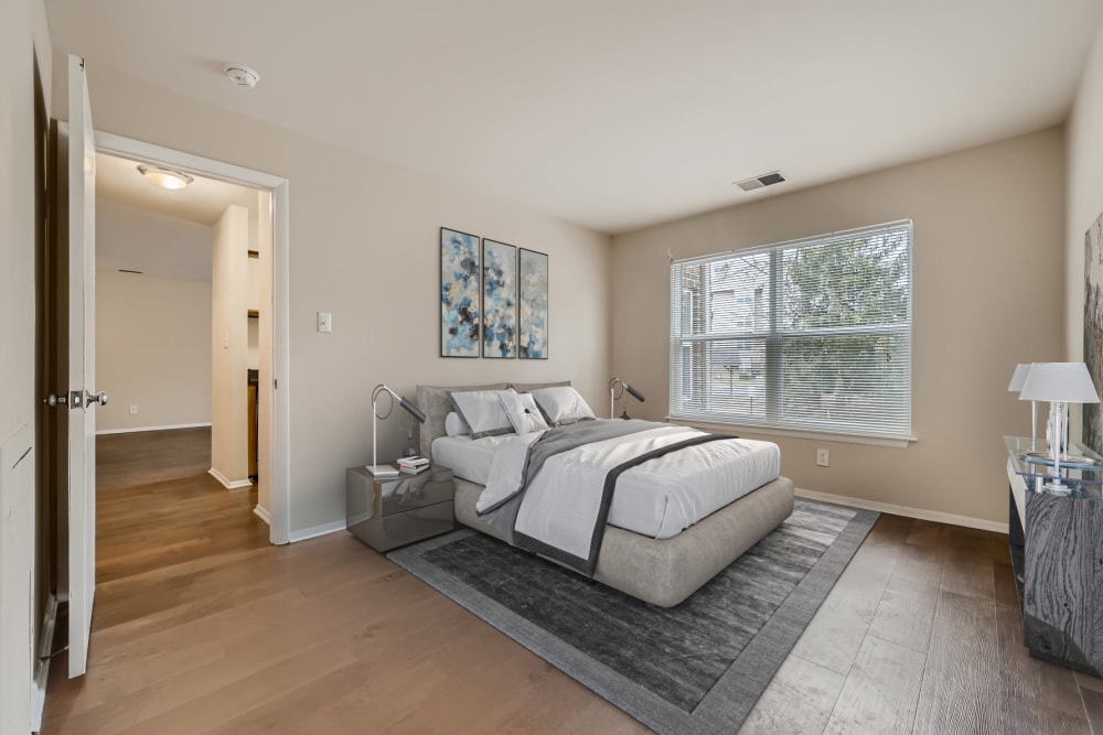 A furnished main bedroom in a model apartment at Hunt Club in Gaithersburg, Maryland