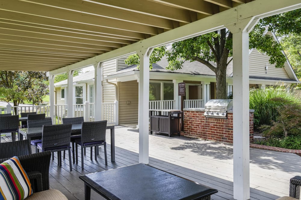 Covered outdoor seating by the grill station at Springwoods at Lake Ridge in Woodbridge, Virginia