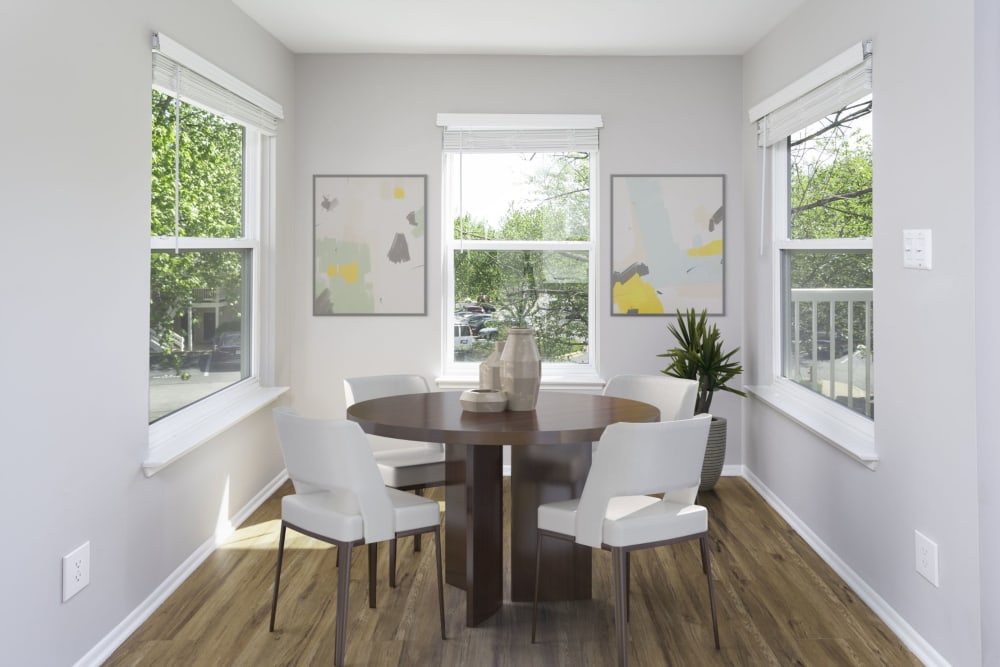 Wood flooring, a dining table and chairs in an apartment dining room at Springwoods at Lake Ridge in Woodbridge, Virginia