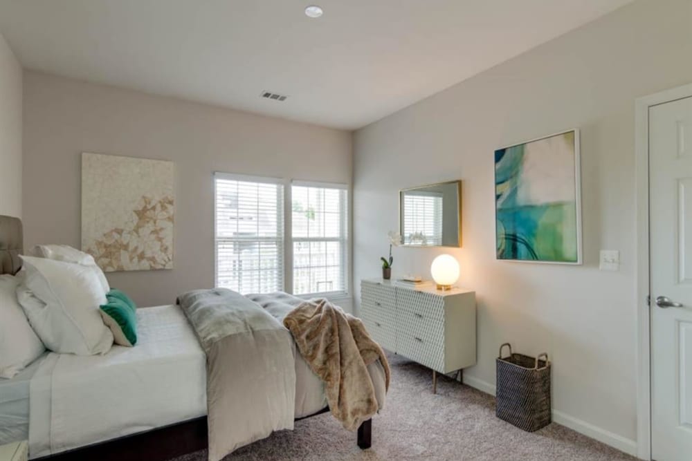 A furnished, well-lit main bedroom in an apartment at Park at Kingsview Village in Germantown, Maryland