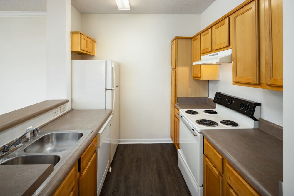 An apartment kitchen with plenty of counter space at The Oaks of St. Clair in Moody, Alabama