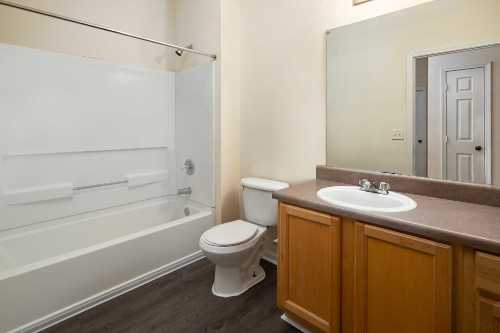 An apartment bathroom with a bathtub at The Oaks of St. Clair in Moody, Alabama