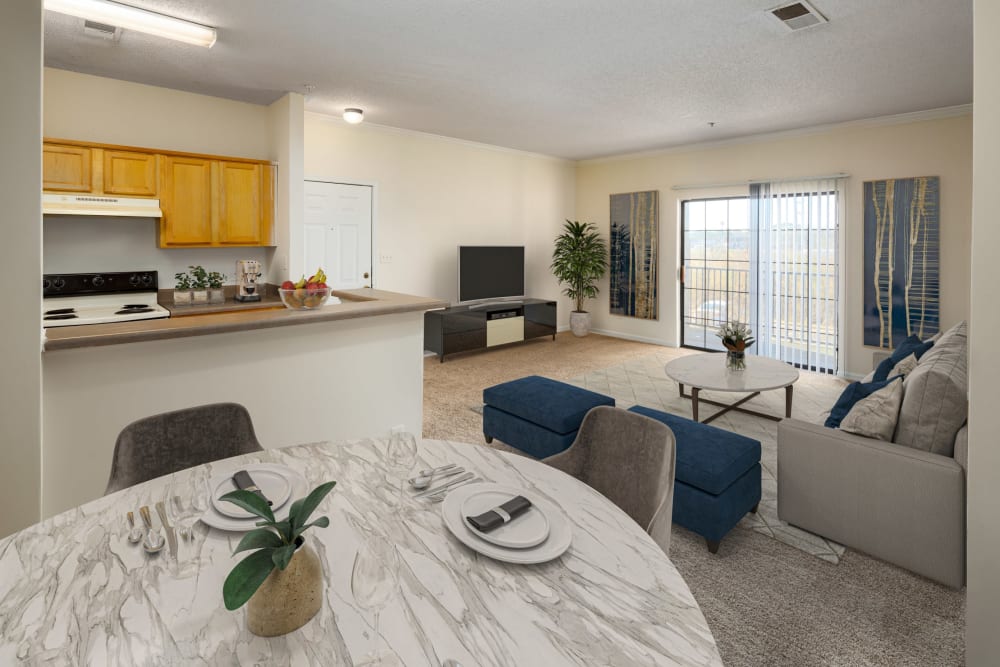 An apartment dining room, kitchen and living room at The Oaks of St. Clair in Moody, Alabama