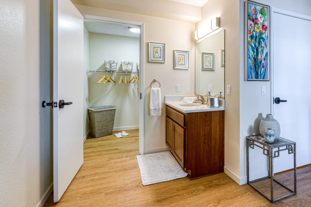 Resident bathroom leading into closet at Pacifica Senior Living Menifee in Sun City, California