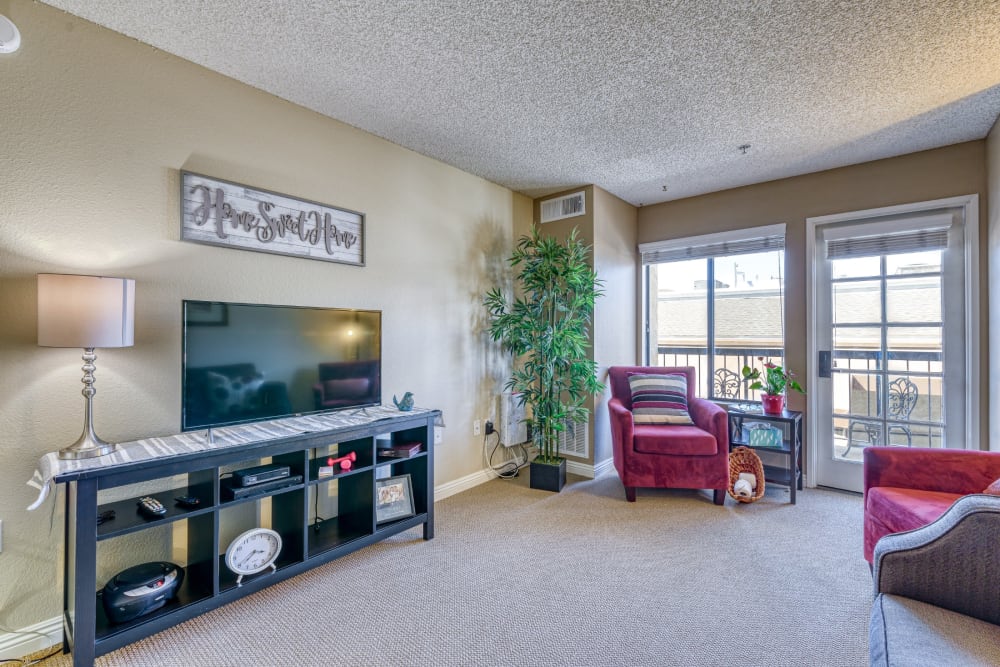 Resident living room with balcony at Pacifica Senior Living Menifee in Sun City, California