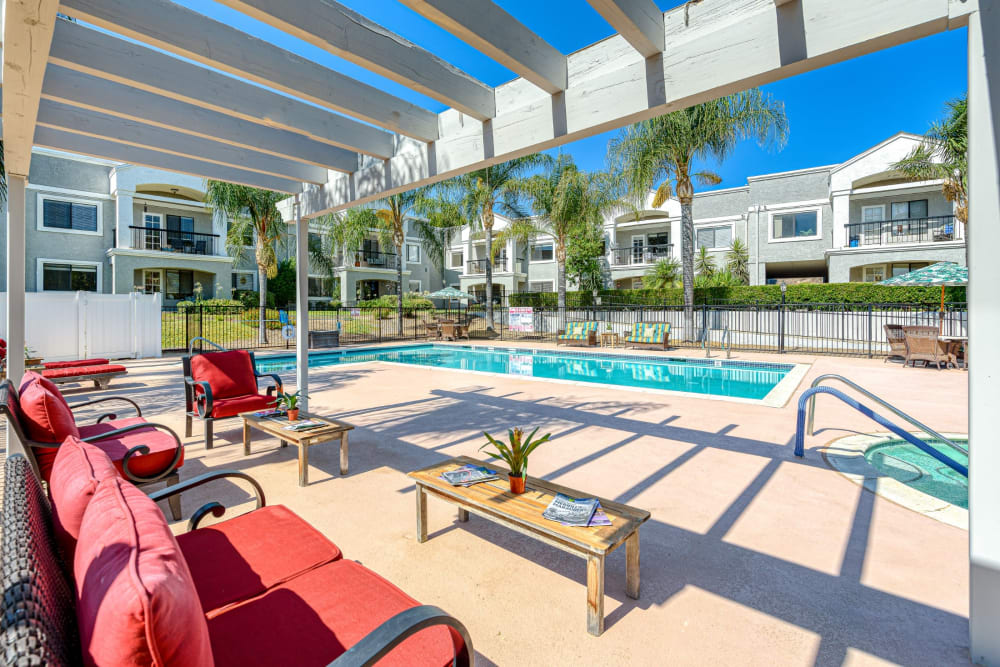 Outdoor pool with seating at Pacifica Senior Living Menifee in Sun City, California