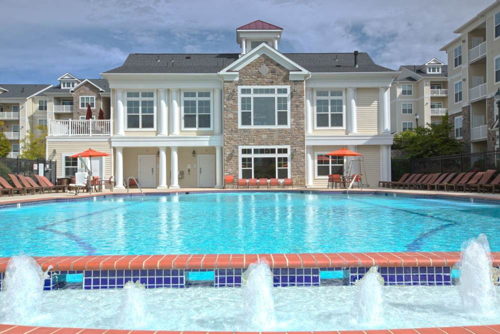 Apartment building overlooking swimming pool at The Elms at Clarksburg Village in Clarksburg, Maryland