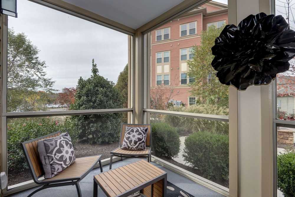 Patio with community building view at The Elms at Odenton in Odenton, Maryland