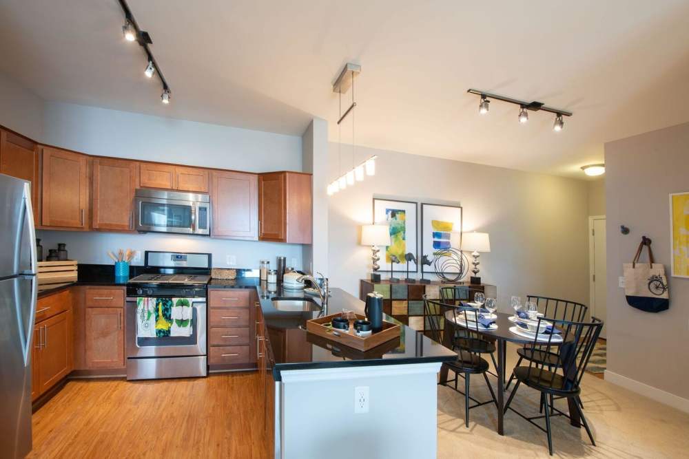 Kitchen with wood-style flooring at The Elms at Arcola in Dulles, Virginia