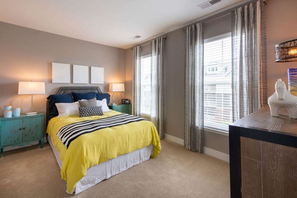 Bedroom with a bed and nightstand at The Elms at Arcola in Dulles, Virginia