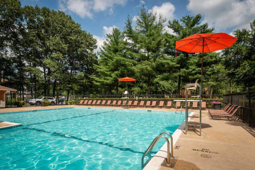 Swimming pool with sunlounger at The Elms at Old Mill in Millersville, Maryland