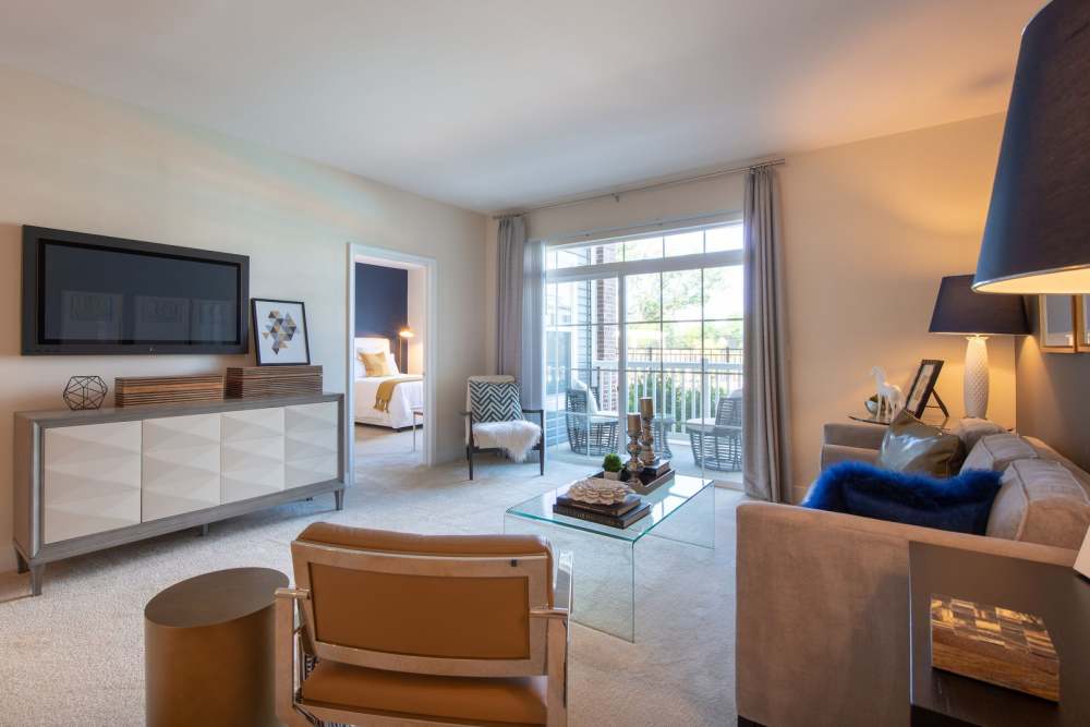 Living room with attached balcony at The Elms at Shannon's Glen in Jessup, Maryland