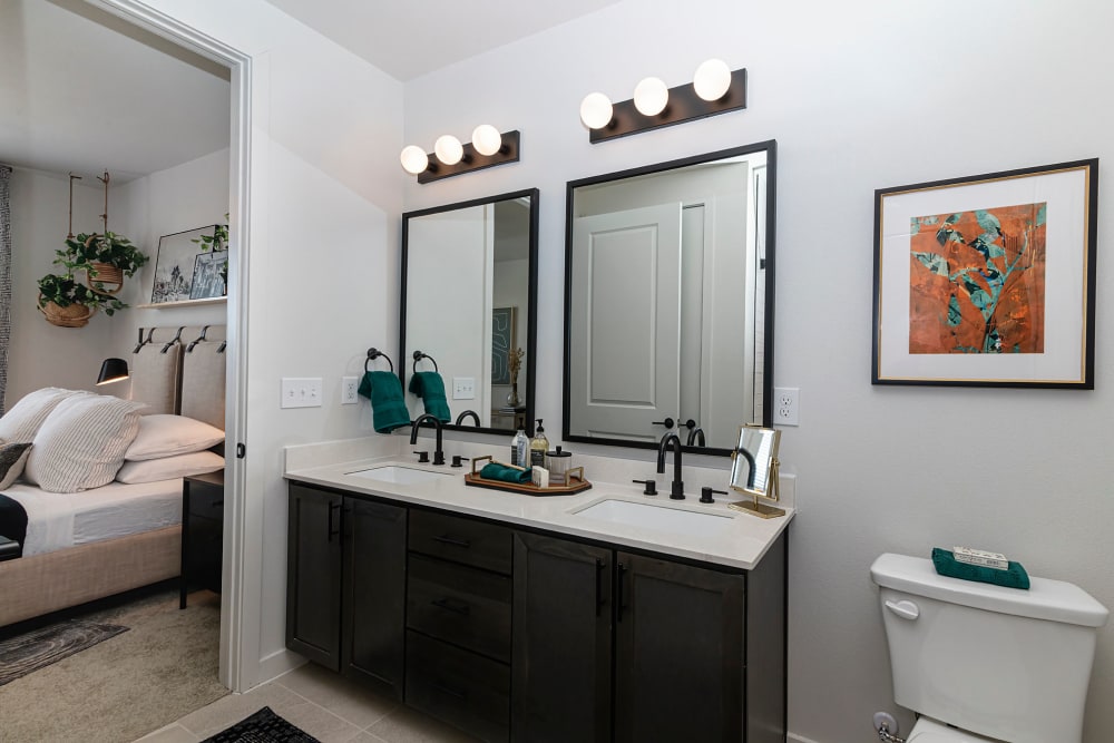 Comfort room with two vanity mirrors at Auro Crossing in Austin, Texas