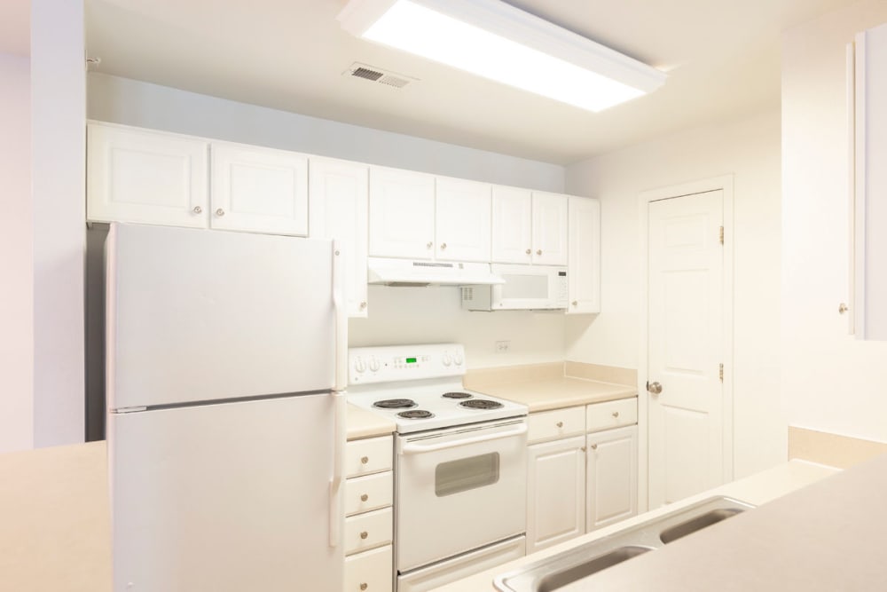 Kitchen with white appliances at The Greens at Sunchase in Farmville, Virginia