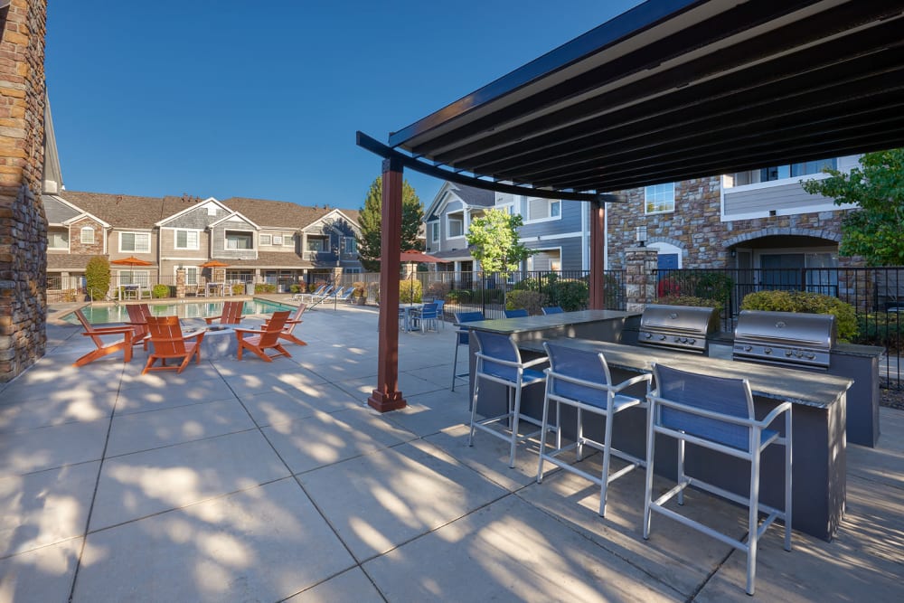 A grilling area by the pool at Crestone Apartments in Aurora, Colorado